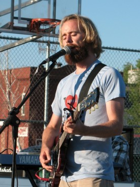 Shane Reichart with a huge beard playing electric guitar