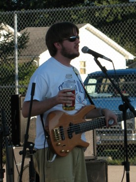 Eric Bright talking into a mic while holding a bottle of apple juice