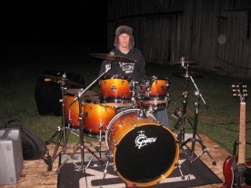McLain Schaefer playing drums in a winter hat